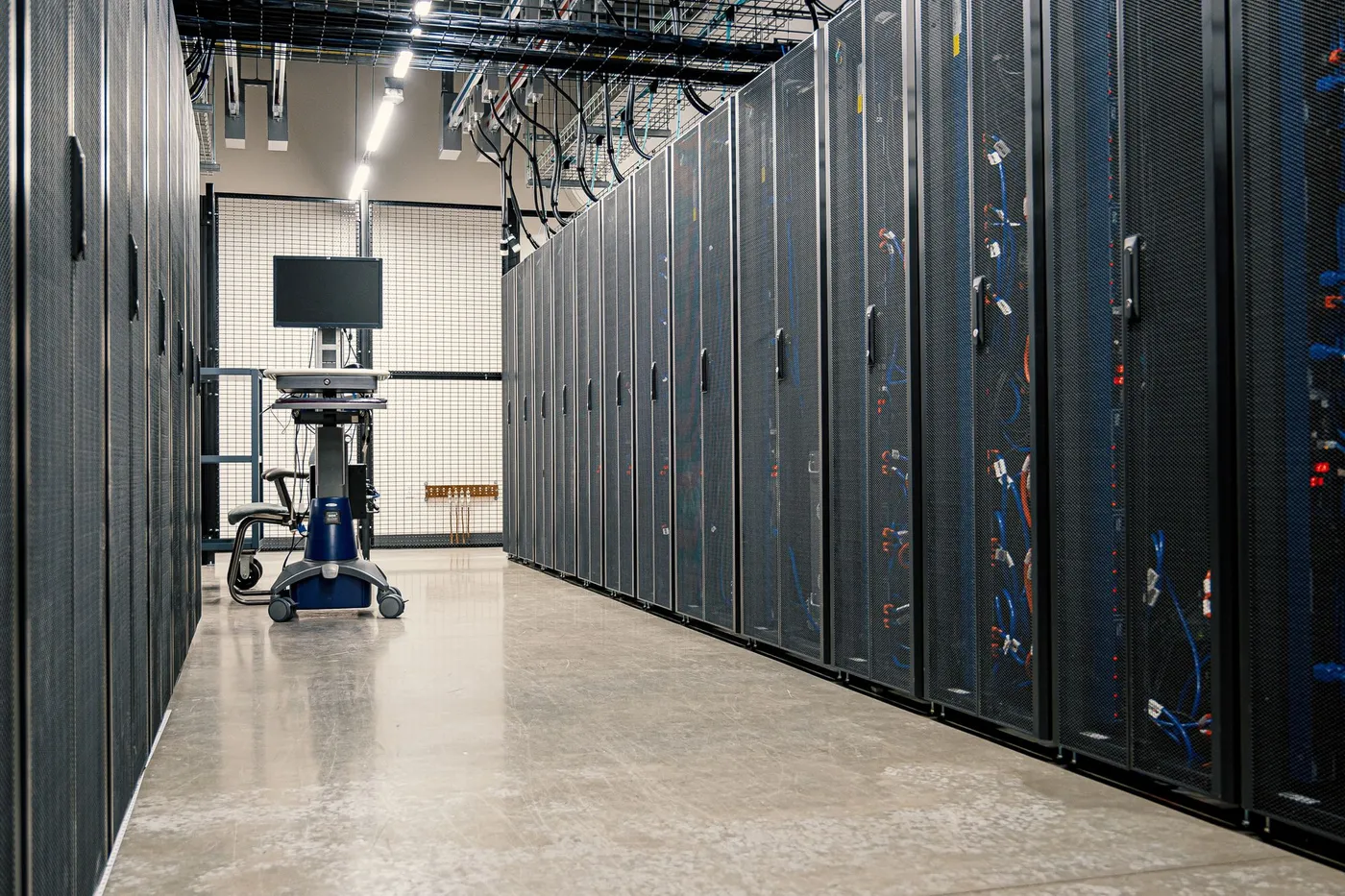 Long corridor between rows of server racks in a data center